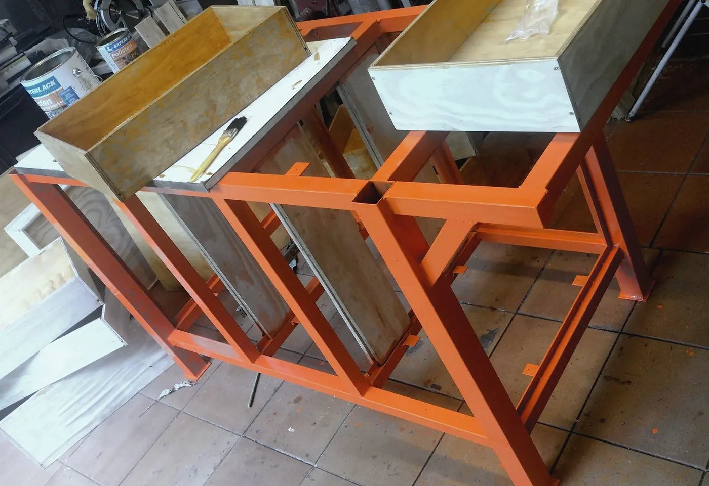Orange workbench frames with the first wooden drawers
