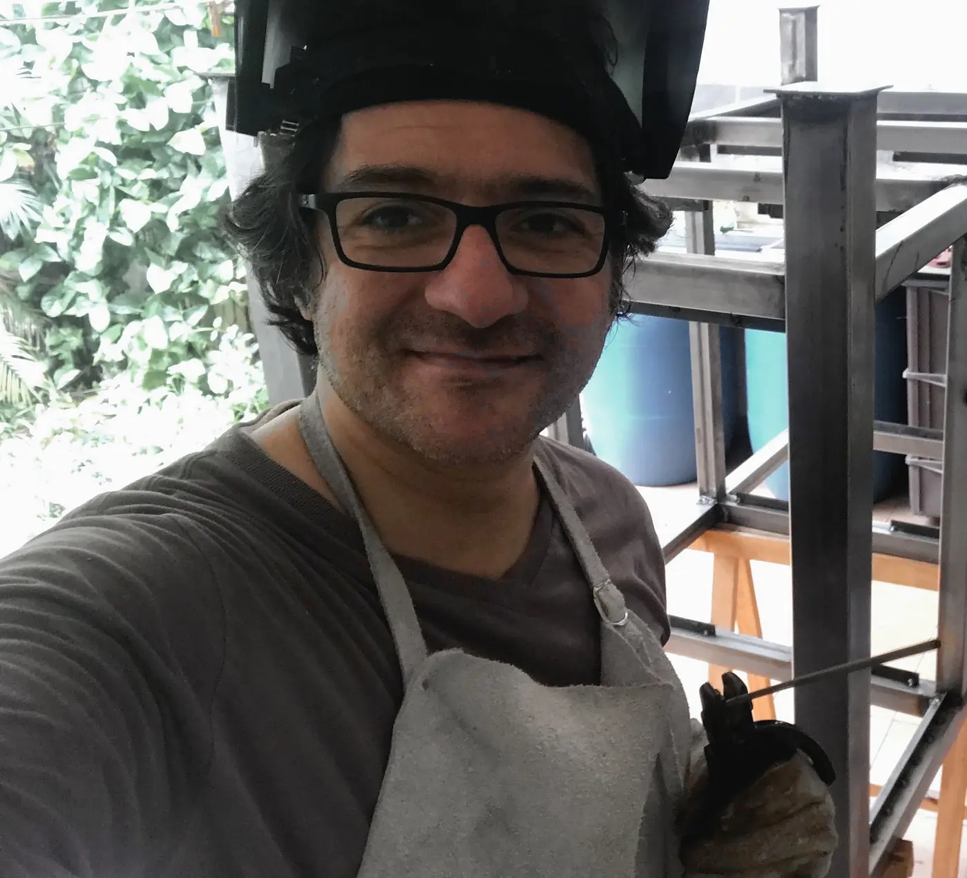 Solano in the workshop with his welding helmet flipped up